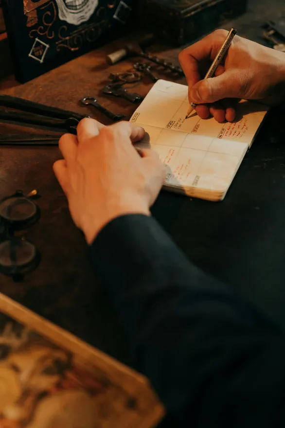 man writing in his planner