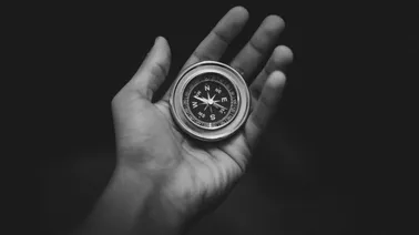 hand holding compass