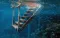 decrepit staircase leading down to a coral reef